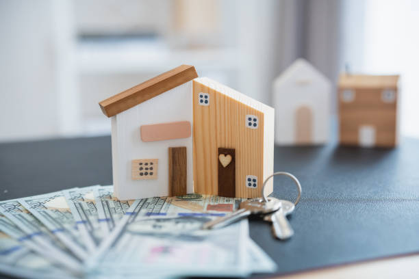 House model on a table with cash and keys in West Bloomfield