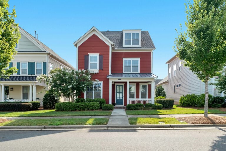 white and brown house with landscaped lawn during daytime