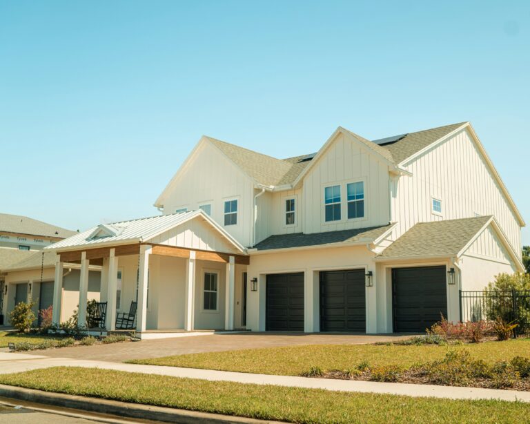 a large white house with two garage