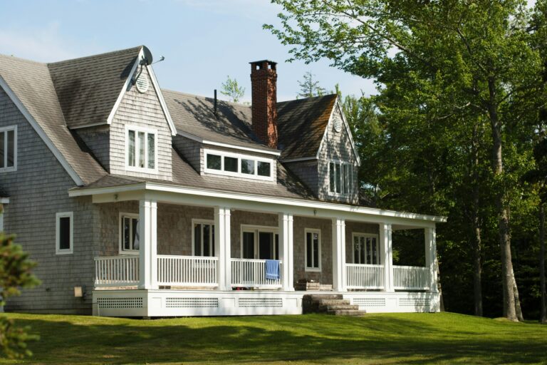 white and brown house near green trees