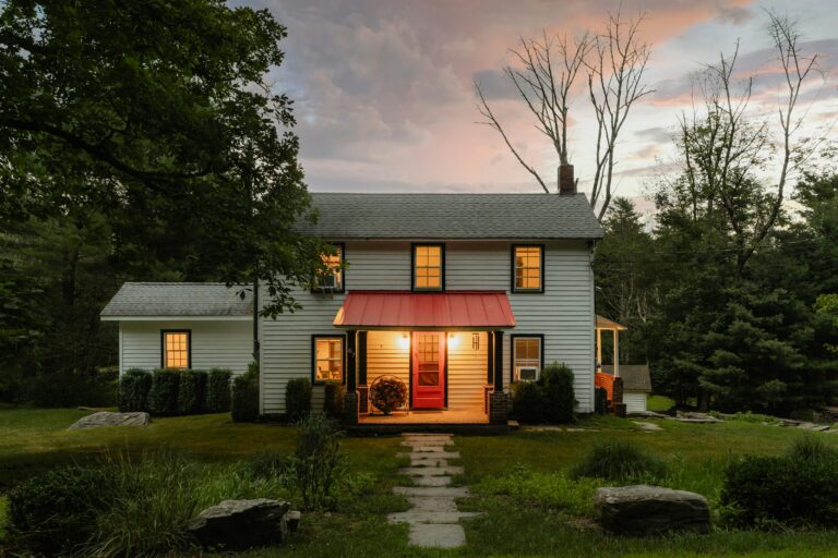 a two story house with a small red awning