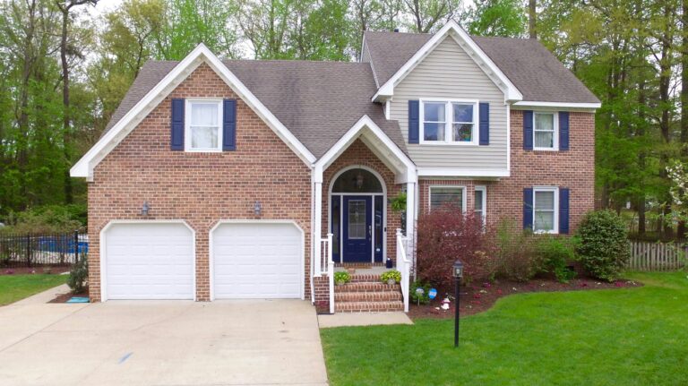 a large brick house with two garage