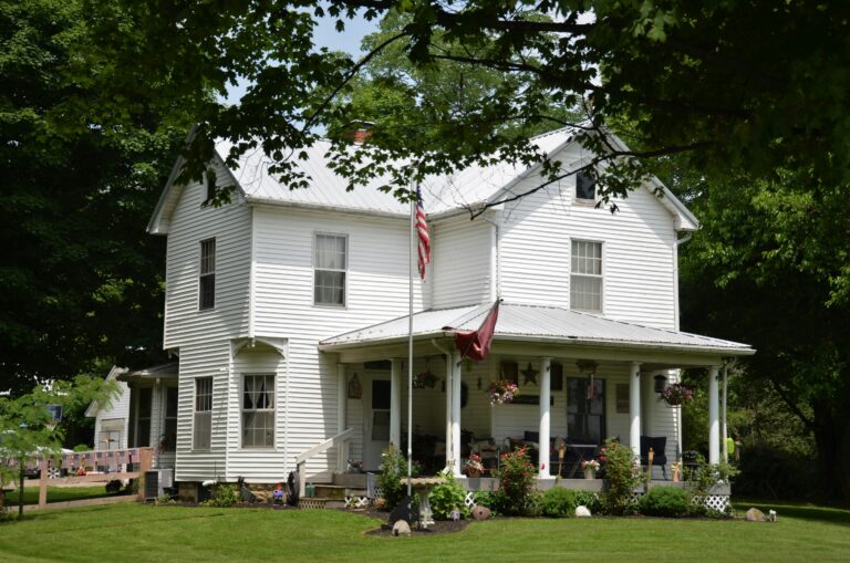 a white house with a flag in frontyard