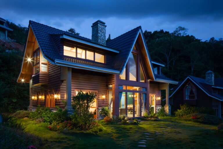 brown and black wooden house with full grown trees on the back
