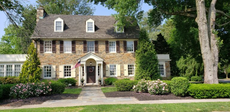 brown bricked two-story house during daytime