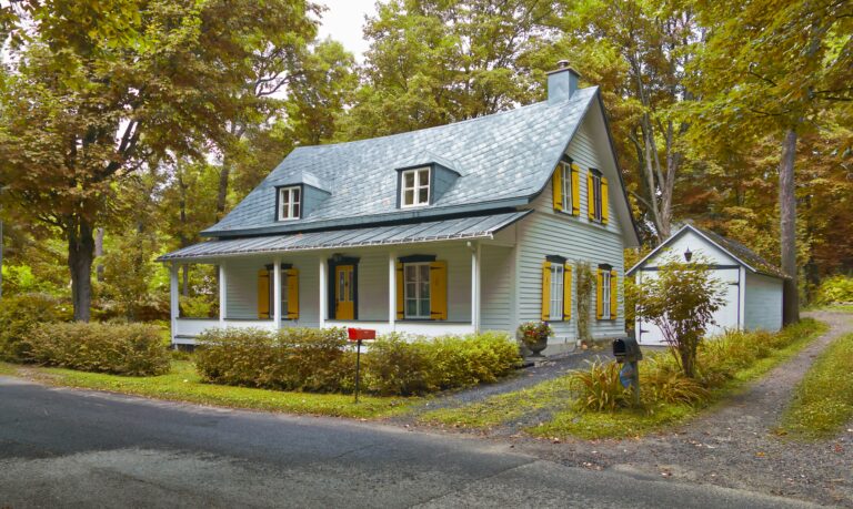 a house with blue roof and yellow shutters