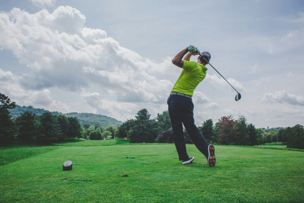 a man swinging a golf driver