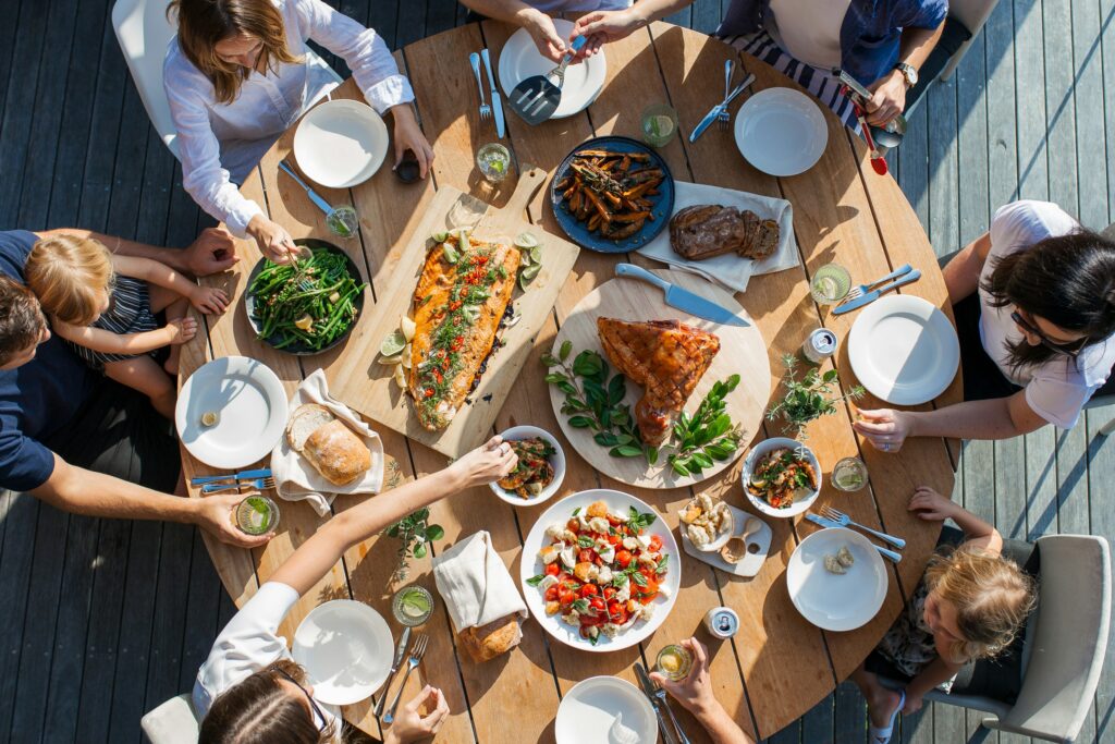 people on a table with foods