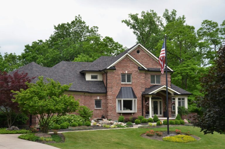 a large brick home with a flag in frontyard