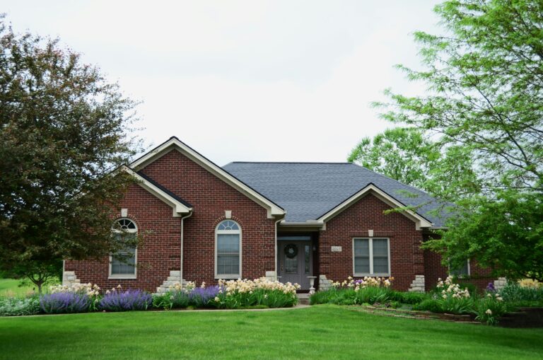 a red brick house with a large front yard