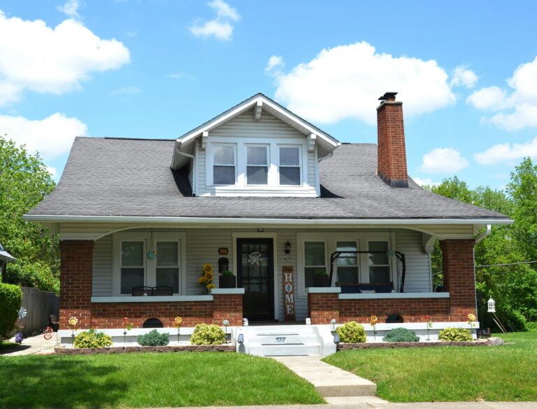 an old craftsman style home with brick porch
