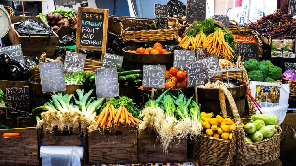 a bunch of vegetable on different baskets on a farmer's market