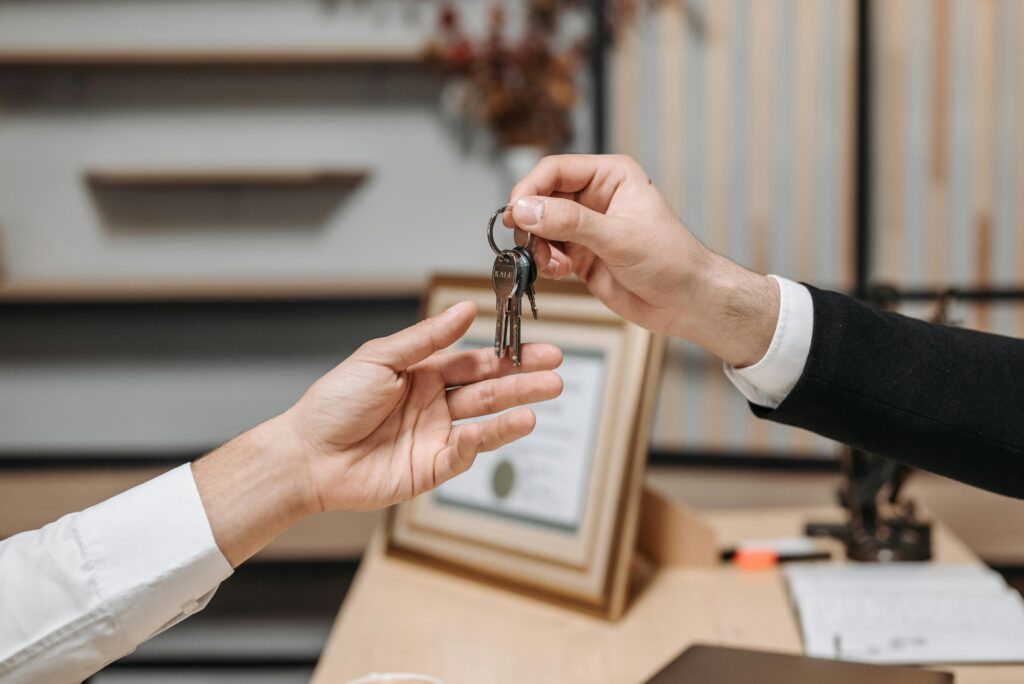 a person handing over the keys